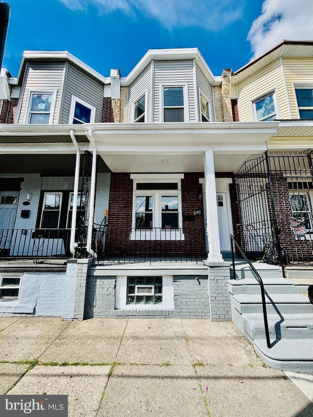 805 W Bristol St, Philadelphia, PA 19140 - townhome / multi-family property with covered porch and brick siding