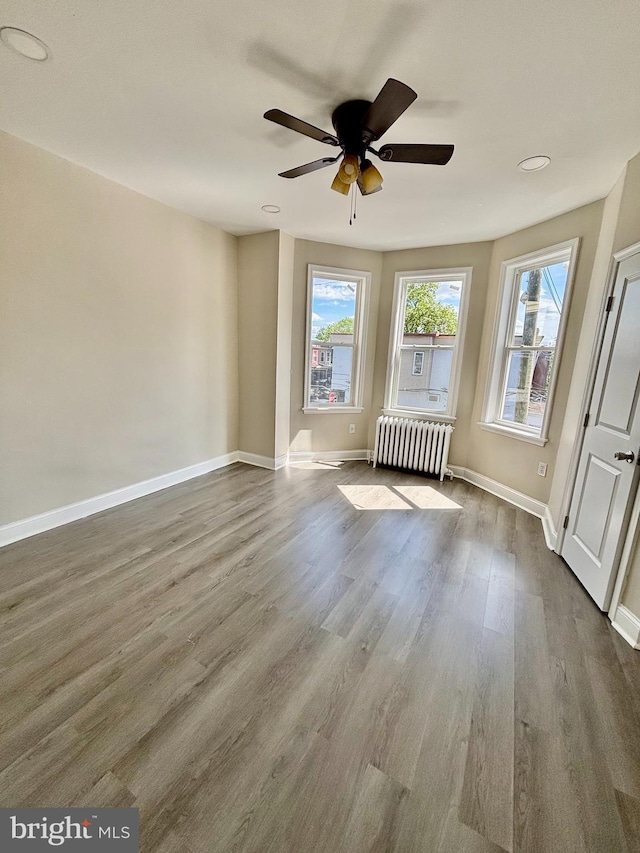805 W Bristol St, Philadelphia, PA 19140 - spare room with radiator heating unit, dark wood finished floors, a ceiling fan, baseboards, and recessed lighting