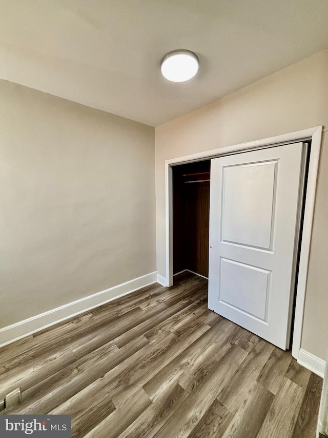 805 W Bristol St, Philadelphia, PA 19140 - unfurnished bedroom with wood finished floors, baseboards, and a closet
