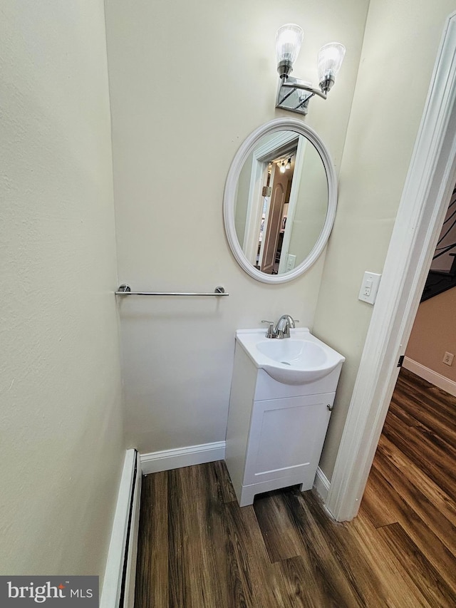 805 W Bristol St, Philadelphia, PA 19140 - bathroom with a baseboard radiator, wood finished floors, vanity, and baseboards