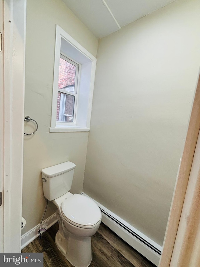 805 W Bristol St, Philadelphia, PA 19140 - bathroom featuring a baseboard heating unit, wood finished floors, toilet, and baseboards