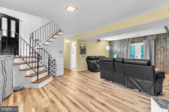 9501 Nottingham Dr, Upper Marlboro, MD 20772 - living room featuring a textured ceiling, wood finished floors, baseboards, and stairway