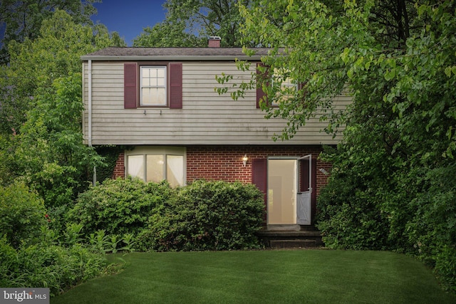 2029 Norhurst Way S, Baltimore, MD 21228 - view of front facade with a front yard, a chimney, and brick siding