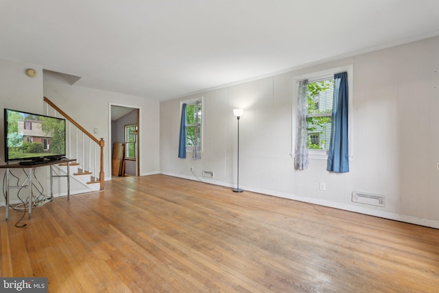 2029 Norhurst Way S, Baltimore, MD 21228 - unfurnished living room with wood finished floors, stairs, and plenty of natural light