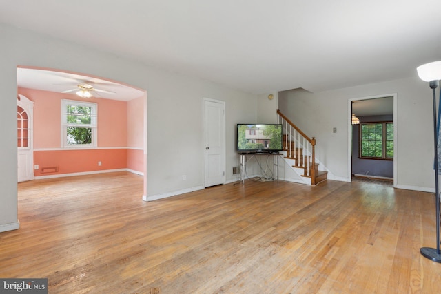 2029 Norhurst Way S, Baltimore, MD 21228 - unfurnished living room featuring stairway, light wood finished floors, ceiling fan, and baseboards
