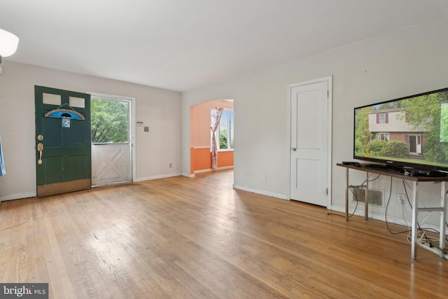 2029 Norhurst Way S, Baltimore, MD 21228 - unfurnished living room with arched walkways, wood finished floors, healthy amount of natural light, and baseboards