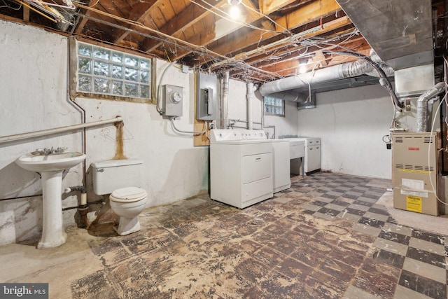 2029 Norhurst Way S, Baltimore, MD 21228 - basement with washing machine and dryer, electric panel, heating unit, a sink, and tile patterned floors