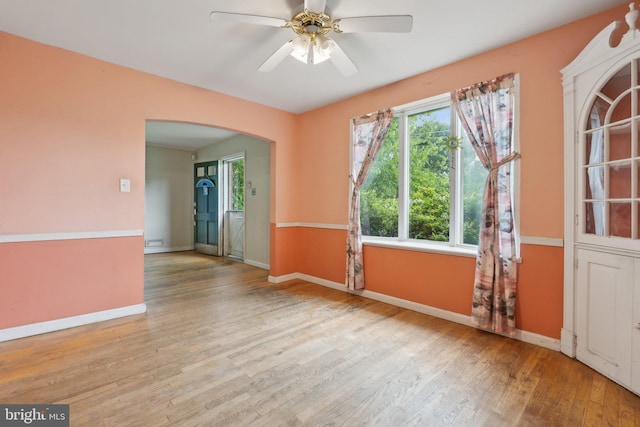 2029 Norhurst Way S, Baltimore, MD 21228 - spare room with wood finished floors, baseboards, arched walkways, and a ceiling fan