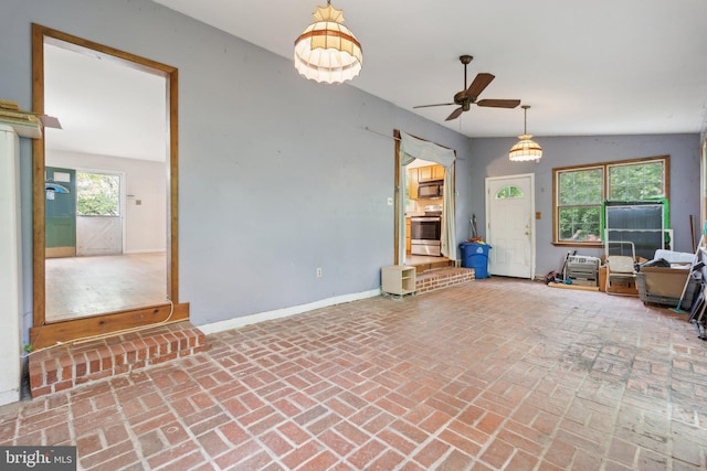 2029 Norhurst Way S, Baltimore, MD 21228 - unfurnished living room featuring a ceiling fan, brick flooring, and baseboards