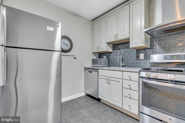 4201 Cathedral Ave NW Unit 918W, Washington, DC 20016 - kitchen featuring appliances with stainless steel finishes, wall chimney exhaust hood, a sink, and decorative backsplash