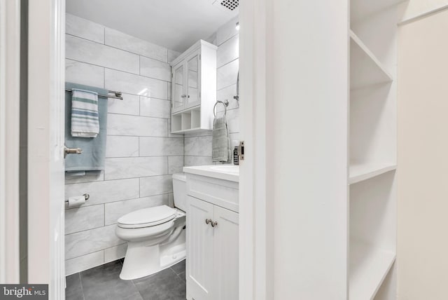 4201 Cathedral Ave NW Unit 918W, Washington, DC 20016 - bathroom featuring tile walls, tile patterned floors, vanity, and toilet