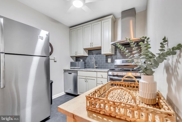 4201 Cathedral Ave NW Unit 918W, Washington, DC 20016 - kitchen featuring stainless steel appliances, wall chimney range hood, a sink, decorative backsplash, and ceiling fan