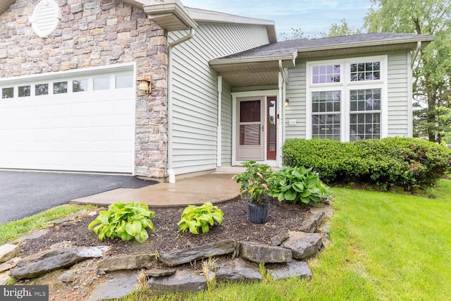 120 Jefferson Cir, Bellefonte, PA 16823 - doorway to property featuring an attached garage, stone siding, and a yard