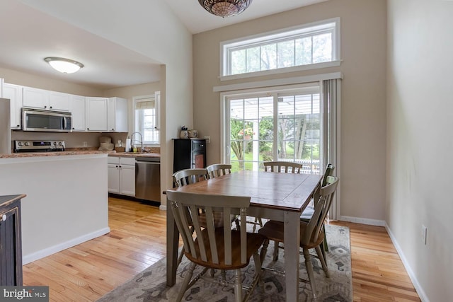 120 Jefferson Cir, Bellefonte, PA 16823 - dining room with light wood finished floors, a high ceiling, and baseboards