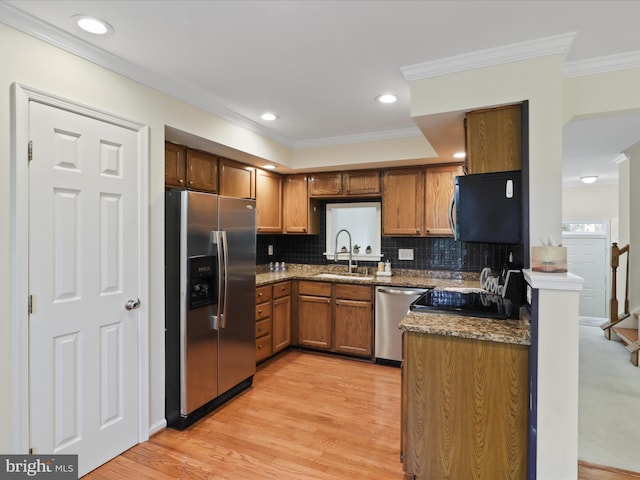 10612 Winfield Loop, Manassas, VA 20109 - kitchen featuring appliances with stainless steel finishes, a sink, ornamental molding, brown cabinetry, and decorative backsplash