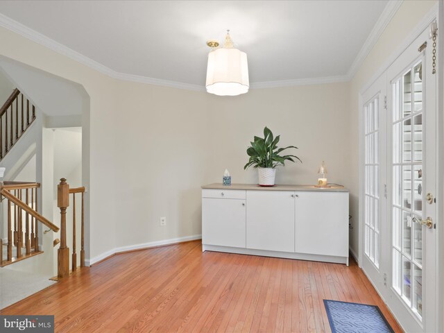 10612 Winfield Loop, Manassas, VA 20109 - unfurnished dining area with light wood-style floors, crown molding, stairs, and baseboards