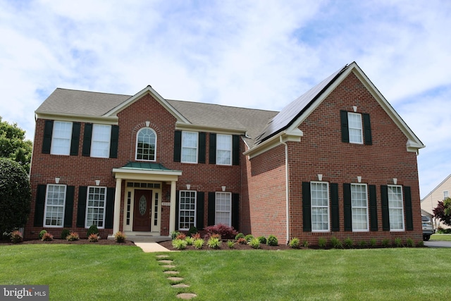 8149 Timberneck Dr, Berlin, MD 21811 - colonial inspired home with brick siding, a front lawn, and solar panels