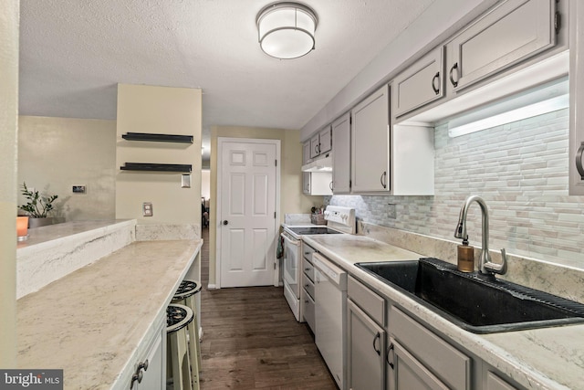 43 Cranberry Ct, Marlton, NJ 08053 - kitchen featuring white appliances, a sink, dark wood-type flooring, under cabinet range hood, and backsplash