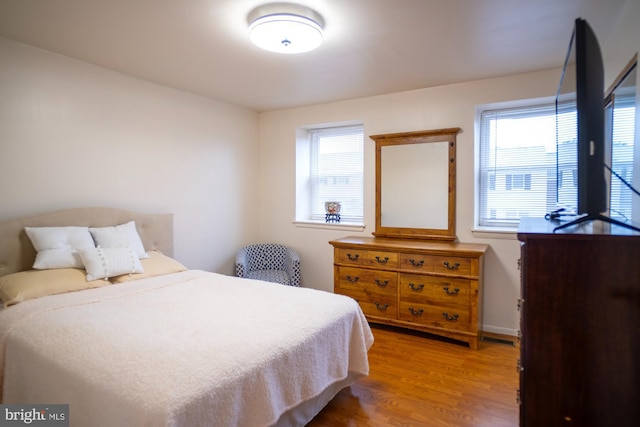 6408 Jefferson Pl, Glen Burnie, MD 21061 - bedroom featuring multiple windows, wood finished floors, and baseboards