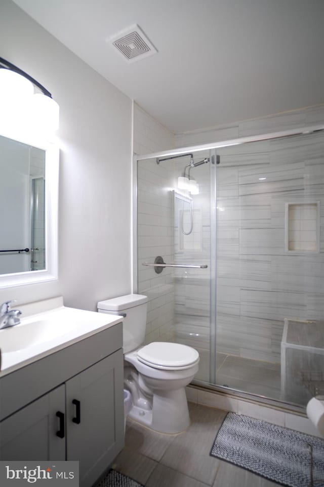 6408 Jefferson Pl, Glen Burnie, MD 21061 - full bathroom with vanity, toilet, a stall shower, and tile patterned flooring