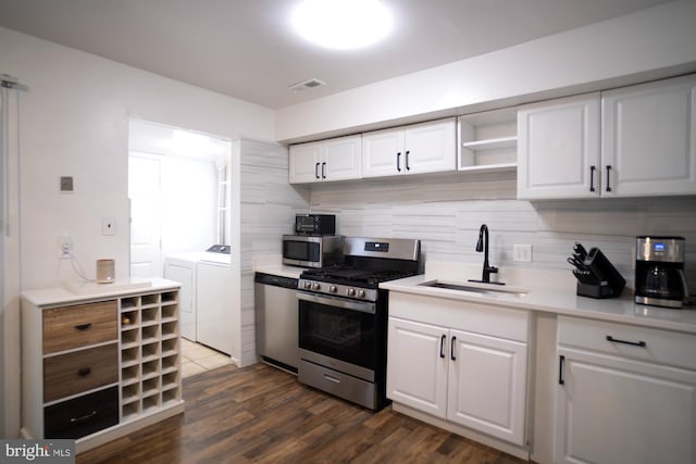 6408 Jefferson Pl, Glen Burnie, MD 21061 - kitchen featuring independent washer and dryer, stainless steel appliances, a sink, decorative backsplash, and light countertops