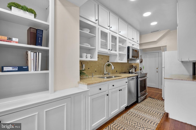1937 38th St NW, Washington, DC 20007 - kitchen with open shelves, stainless steel appliances, white cabinetry, decorative backsplash, and dark wood-type flooring