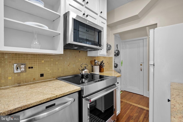 1937 38th St NW, Washington, DC 20007 - kitchen featuring appliances with stainless steel finishes, white cabinetry, dark wood-style floors, backsplash, and light stone countertops