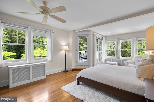 1937 38th St NW, Washington, DC 20007 - bedroom with radiator, access to exterior, multiple windows, wood finished floors, and recessed lighting