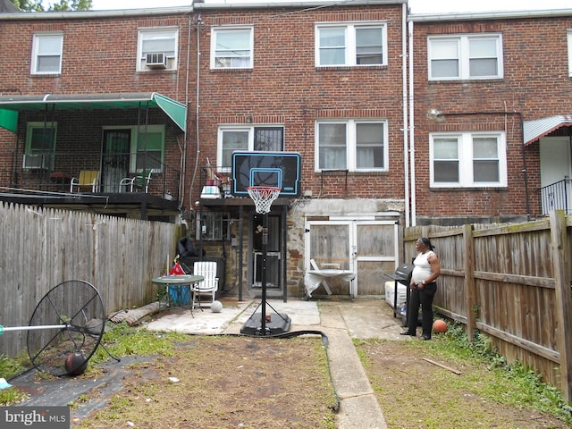 3210 Massachusetts Ave, Baltimore, MD 21229 - rear view of property with brick siding, a fenced backyard, and cooling unit