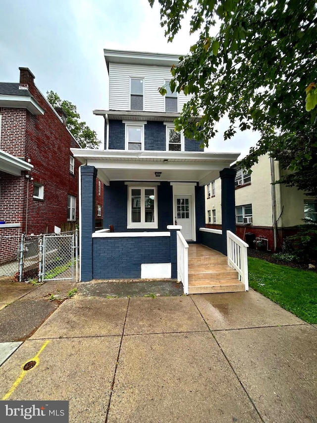 2712 N 6th St, Harrisburg, PA 17110 - traditional style home featuring a porch, a gate, and brick siding