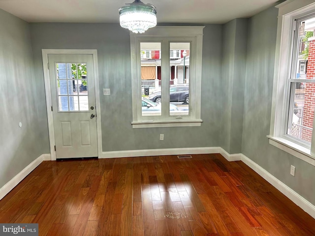 2712 N 6th St, Harrisburg, PA 17110 - doorway to outside with dark wood-style floors, plenty of natural light, a chandelier, and baseboards