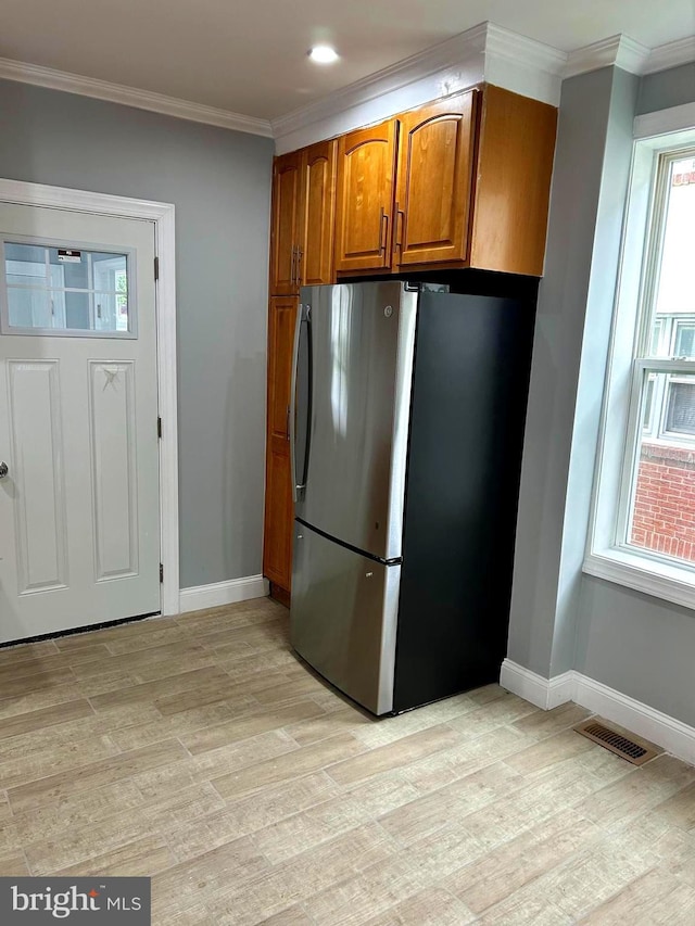2712 N 6th St, Harrisburg, PA 17110 - kitchen featuring freestanding refrigerator, light wood-type flooring, brown cabinets, baseboards, and crown molding