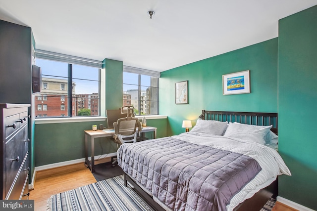 1312 Massachusetts Ave NW Unit 604, Washington, DC 20005 - bedroom with baseboards and wood finished floors