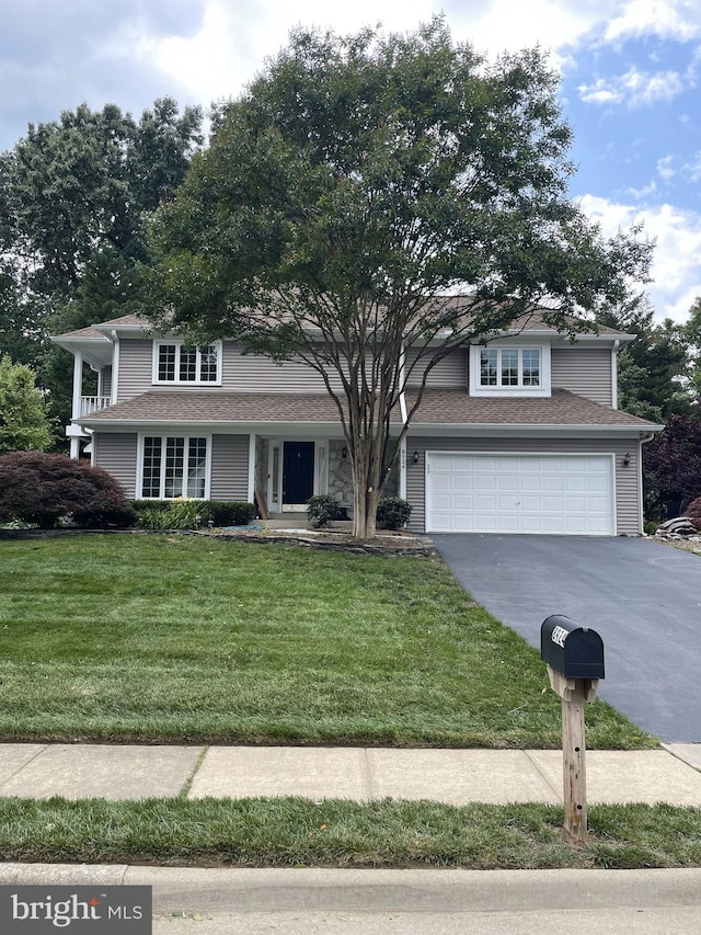 8924 Cross Chase Cir, Lorton, VA 22079 - traditional-style home with concrete driveway, a garage, and a front yard