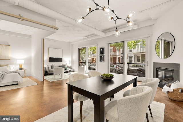 1700 Kalorama Rd NW Unit 206, Washington, DC 20009 - dining room featuring a glass covered fireplace, a chandelier, and baseboards