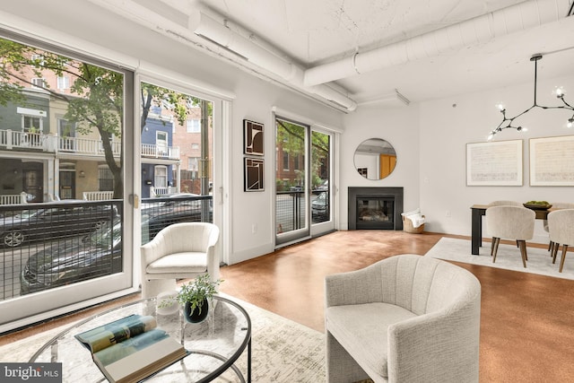 1700 Kalorama Rd NW Unit 206, Washington, DC 20009 - living area with baseboards, a chandelier, beamed ceiling, and a glass covered fireplace