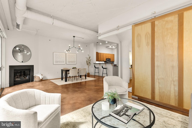 1700 Kalorama Rd NW Unit 206, Washington, DC 20009 - living room featuring a chandelier, a glass covered fireplace, and baseboards