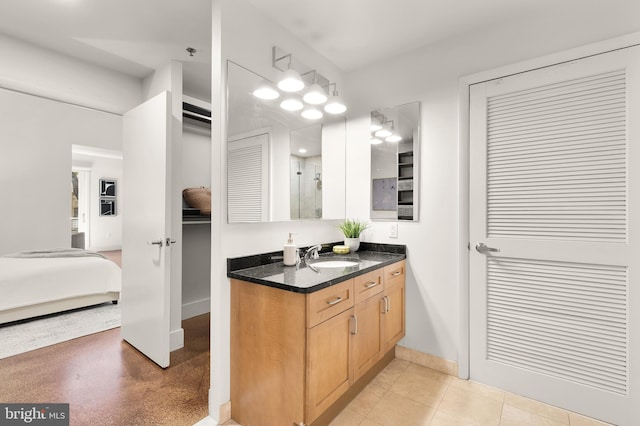 1700 Kalorama Rd NW Unit 206, Washington, DC 20009 - bathroom featuring vanity, ensuite bathroom, a closet, baseboards, and a shower