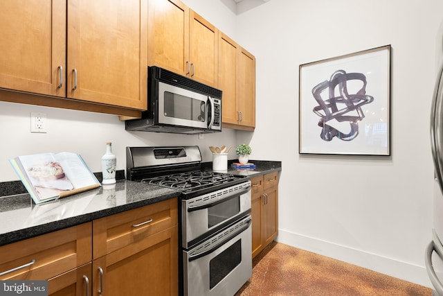 1700 Kalorama Rd NW Unit 206, Washington, DC 20009 - kitchen featuring stainless steel appliances, dark stone countertops, and baseboards