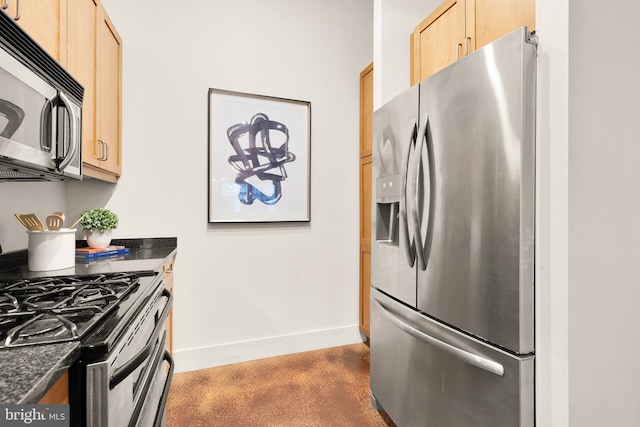 1700 Kalorama Rd NW Unit 206, Washington, DC 20009 - kitchen featuring stainless steel appliances, dark countertops, light brown cabinetry, and baseboards