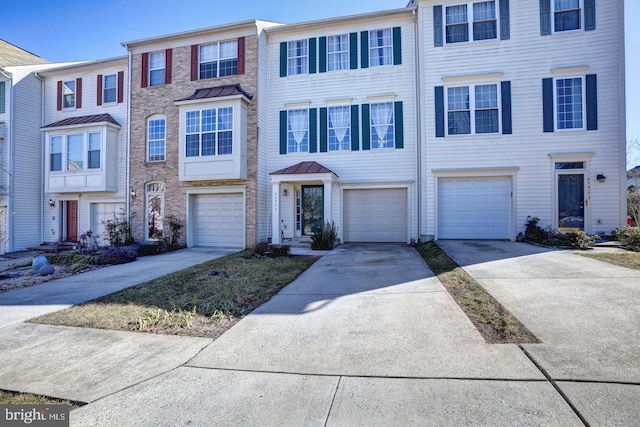 45423 Baggett Ter, Sterling, VA 20166 - view of property with driveway, an attached garage, and a standing seam roof