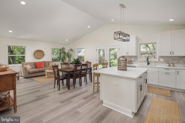 2836 Cameron Rd, Falls Church, VA 22042 - kitchen with a sink, white cabinetry, a center island, decorative backsplash, and pendant lighting