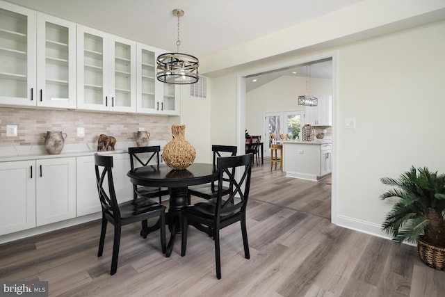 2836 Cameron Rd, Falls Church, VA 22042 - dining area with a chandelier, wood finished floors, vaulted ceiling, and baseboards