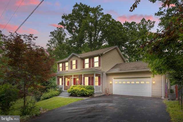 22 Berry Ln, Harpers Ferry, WV 25425 - view of front of property with driveway, a garage, a porch, and a shingled roof