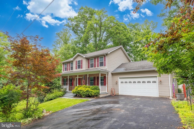 22 Berry Ln, Harpers Ferry, WV 25425 - view of front facade featuring driveway, a garage, covered porch, and a shingled roof