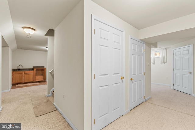 22 Berry Ln, Harpers Ferry, WV 25425 - corridor with light colored carpet, baseboards, and a sink