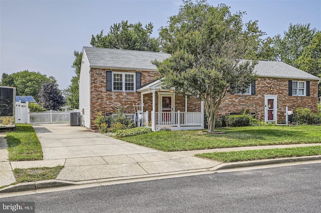 240 Inlet Dr, Pasadena, MD 21122 - bi-level home featuring driveway, brick siding, central AC, a gate, and roof with shingles