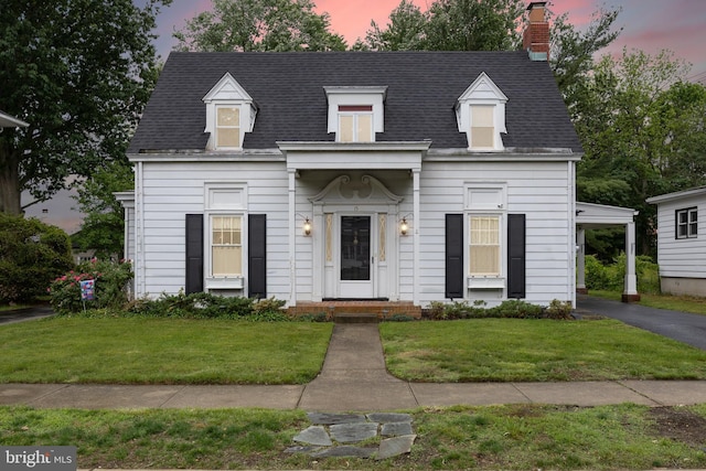 15 E Grant St, Woodstown, NJ 08098 - view of front of house featuring a front yard, roof with shingles, a chimney, and a carport