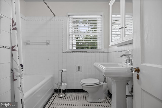 15 E Grant St, Woodstown, NJ 08098 - bathroom featuring shower / bath combo with shower curtain, toilet, and tile walls