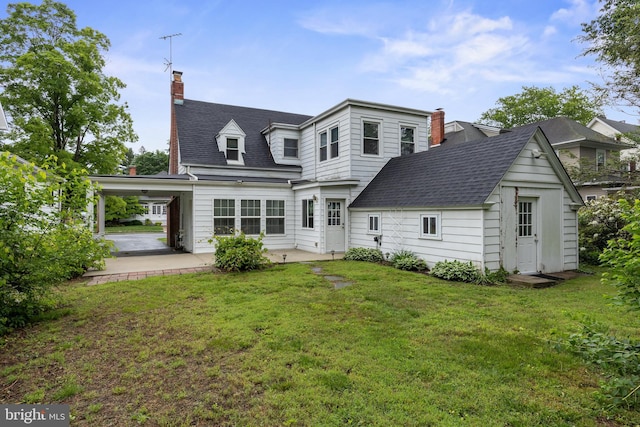 15 E Grant St, Woodstown, NJ 08098 - rear view of house featuring a chimney, a patio, a lawn, and roof with shingles